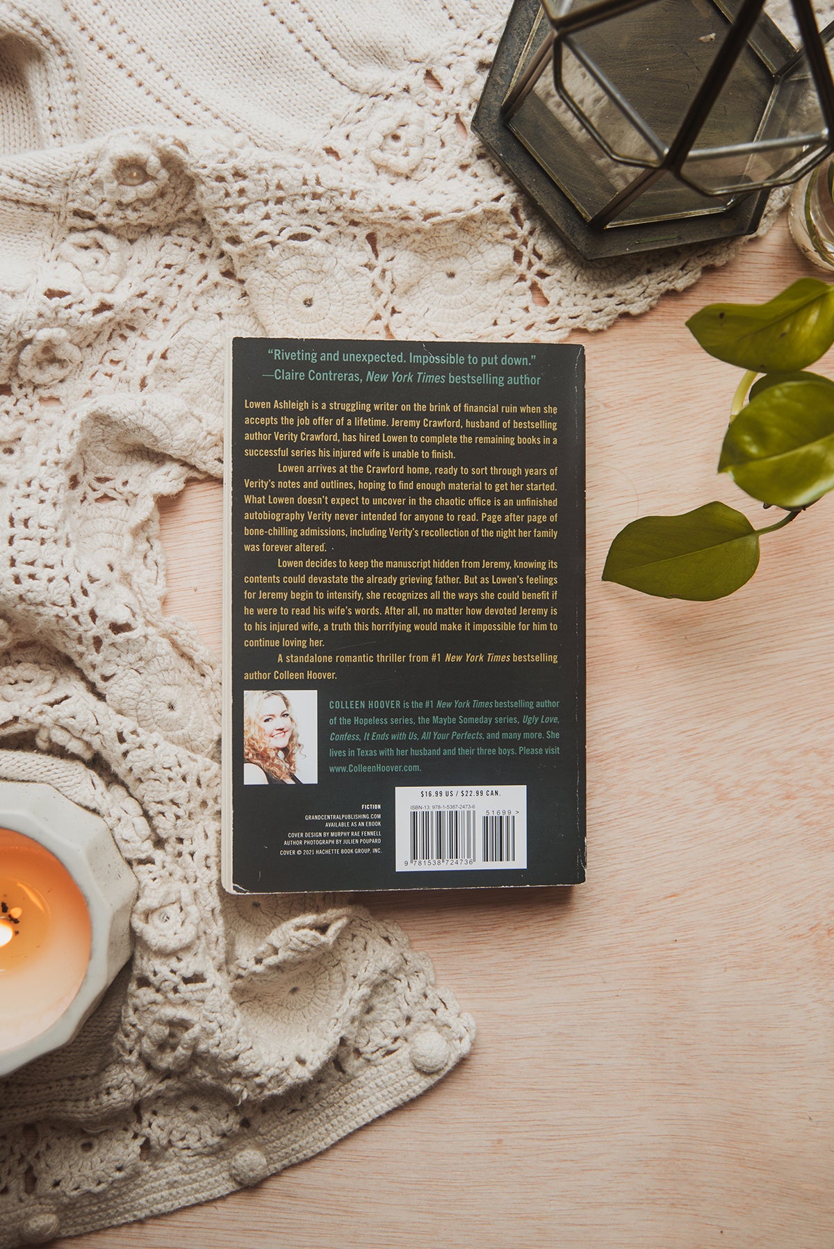 Book on a wooden surface with a candle and decorative elements